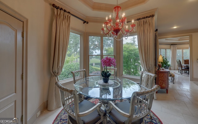 dining room featuring ornamental molding, a raised ceiling, and a notable chandelier