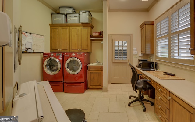 clothes washing area with cabinets, crown molding, washing machine and dryer, and sink