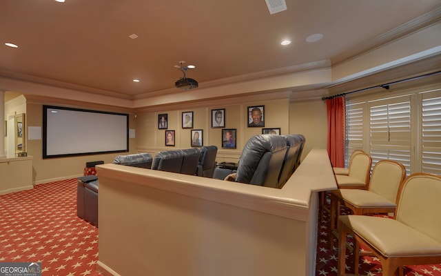 carpeted home theater room with ornamental molding