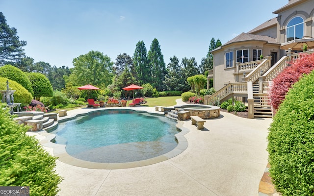 view of swimming pool with a patio area and an in ground hot tub