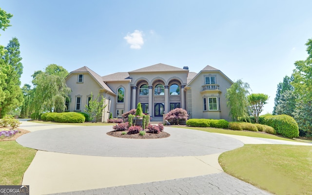 mediterranean / spanish house featuring a front lawn