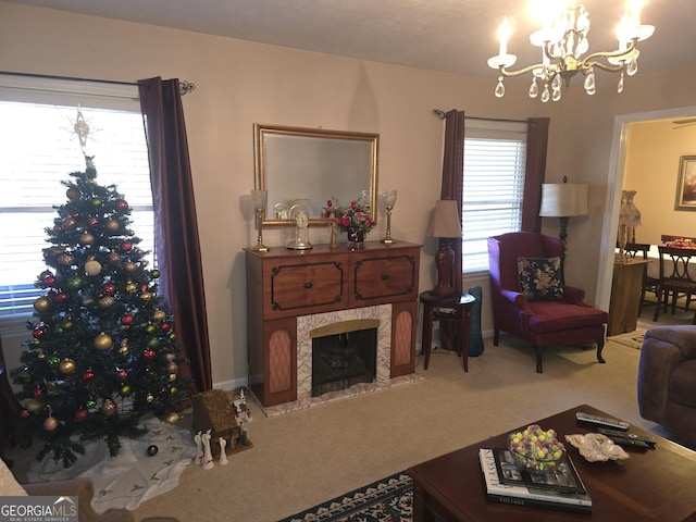 living room featuring carpet floors, a high end fireplace, and an inviting chandelier