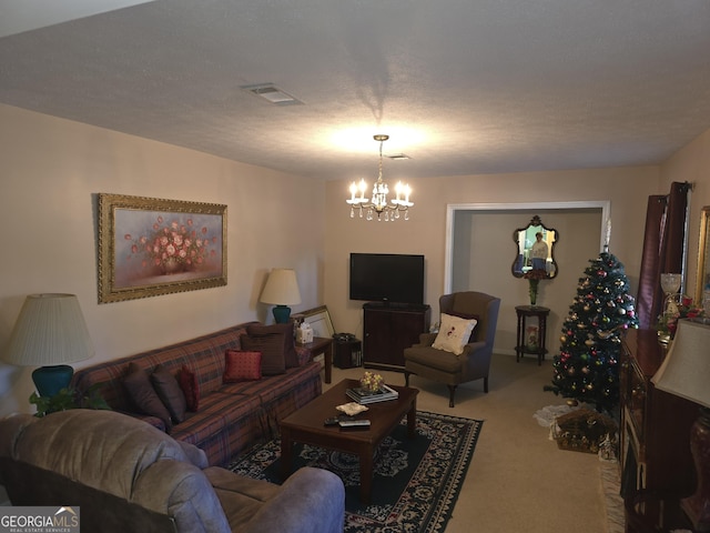 living room featuring a chandelier, a textured ceiling, and carpet flooring