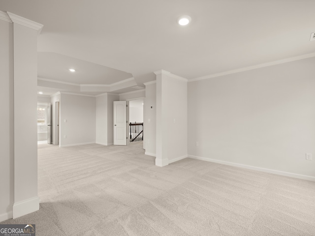 empty room featuring crown molding and light colored carpet