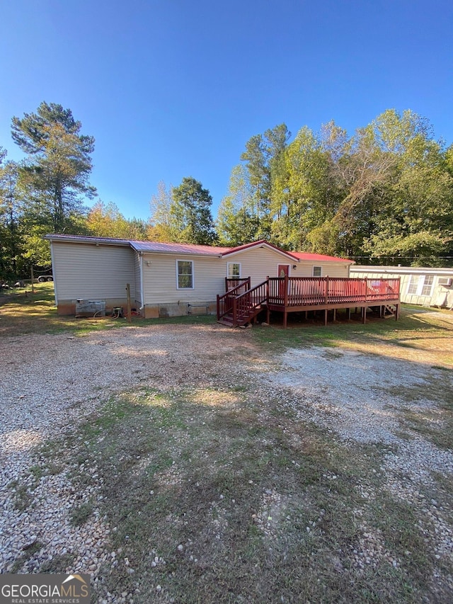 rear view of house with a wooden deck