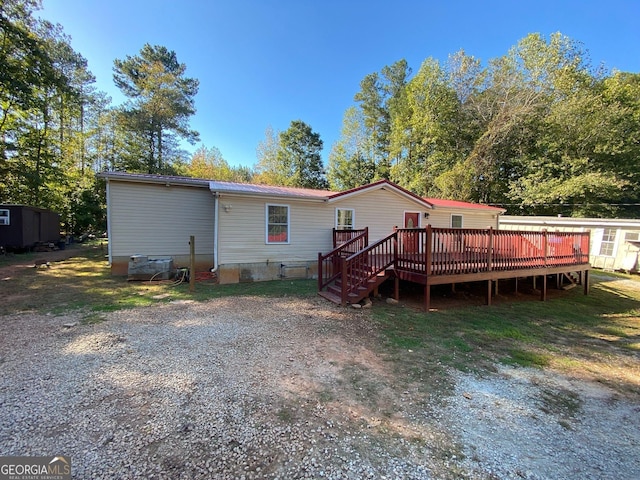 back of house featuring a deck