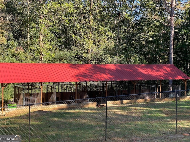 view of property's community with a lawn and an outdoor structure