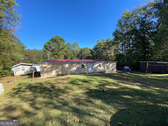 rear view of house featuring a yard