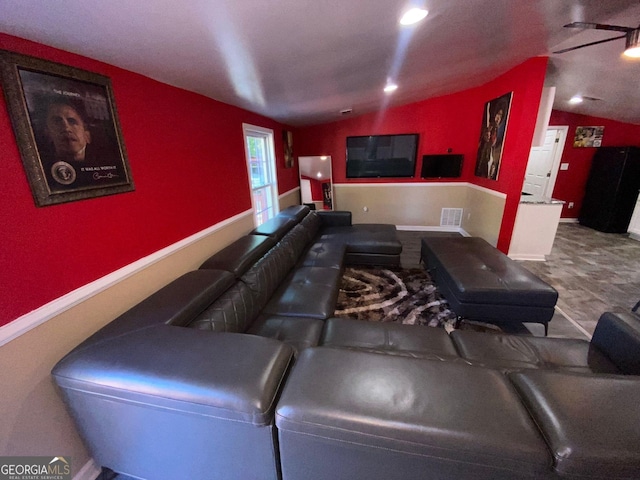 cinema room featuring vaulted ceiling and ceiling fan