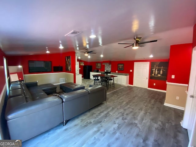 living room with ceiling fan and wood-type flooring