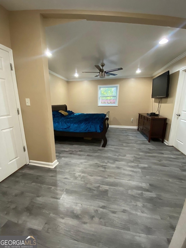 bedroom with ceiling fan, dark wood-type flooring, and crown molding