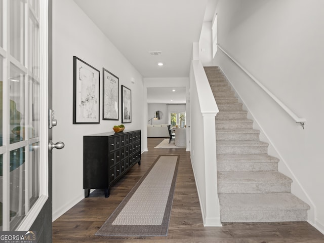 stairway featuring hardwood / wood-style floors