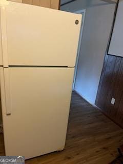 kitchen featuring white refrigerator and dark wood-type flooring