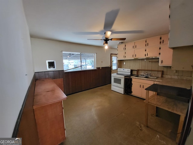 kitchen featuring tasteful backsplash, white range with electric stovetop, ceiling fan, sink, and white cabinets