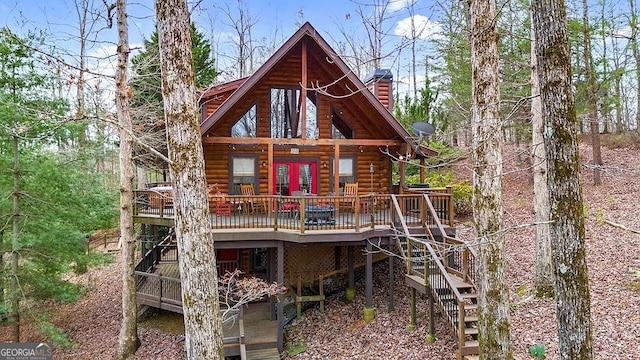 back of property featuring a deck and french doors