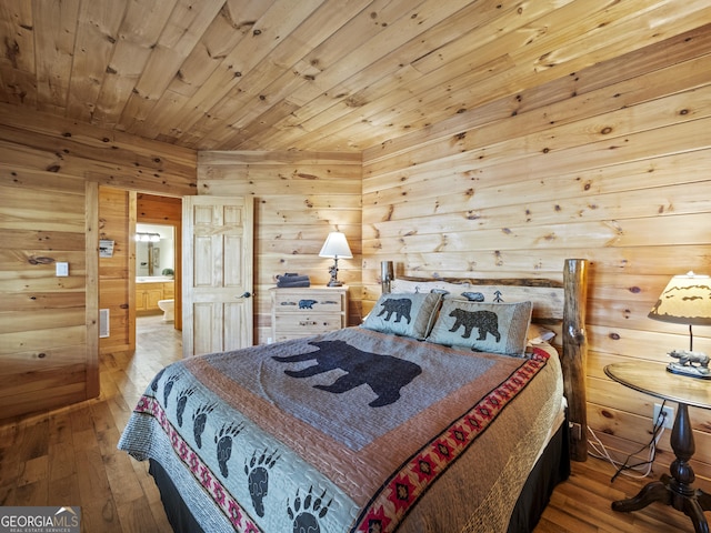 bedroom featuring light wood-type flooring, ensuite bath, wood walls, and wood ceiling