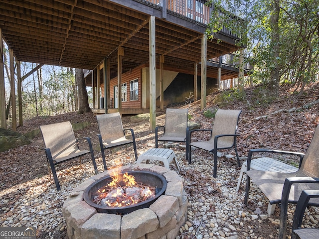 view of patio / terrace with a fire pit and a wooden deck