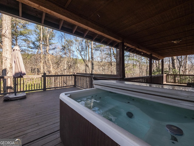 wooden deck featuring a hot tub