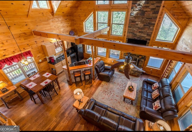 living room featuring wood-type flooring and high vaulted ceiling