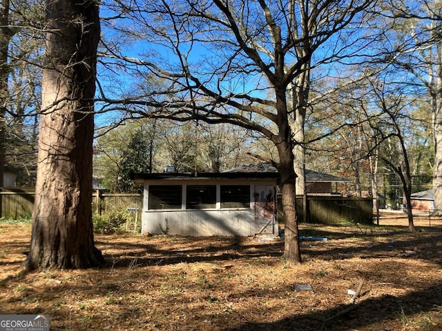 view of property exterior featuring fence