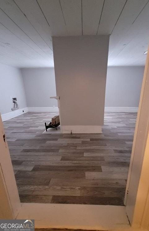 basement featuring baseboards and wood finished floors