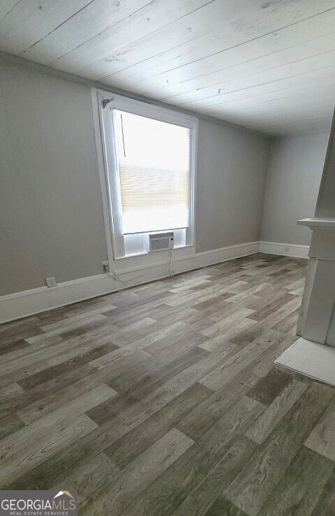 unfurnished room with baseboards and wood finished floors