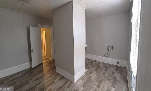 interior space with laundry area, hookup for a washing machine, baseboards, and wood finished floors