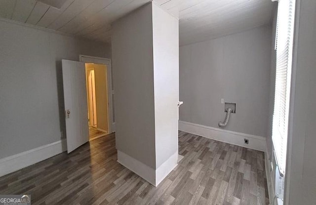 interior space featuring laundry area, wood finished floors, baseboards, and washer hookup