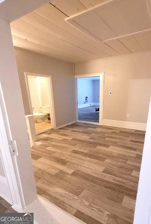 hallway with baseboards and light wood finished floors