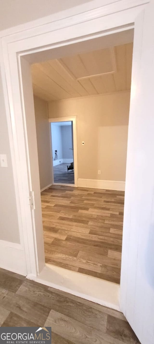 hall with wood finished floors and baseboards