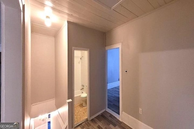 bathroom featuring toilet, wood finished floors, and baseboards