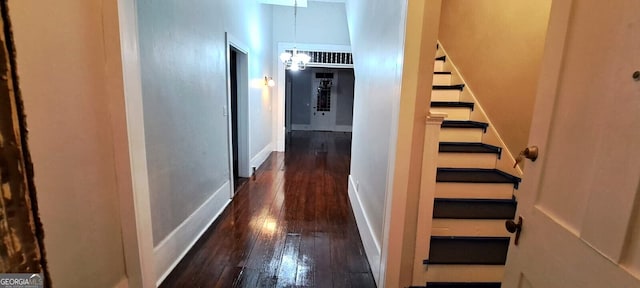 corridor featuring stairs, baseboards, and wood-type flooring