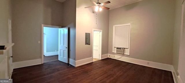 unfurnished bedroom featuring dark wood-style floors, baseboards, and a towering ceiling