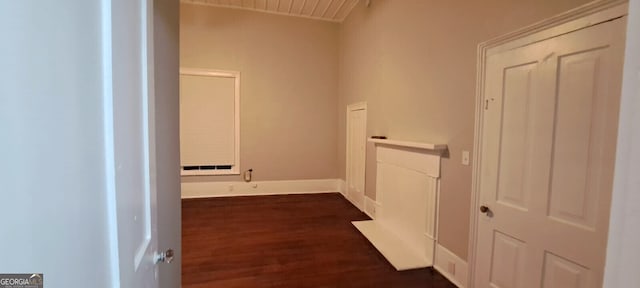 hall featuring dark wood-style floors and baseboards