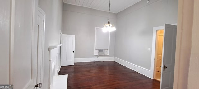 interior space featuring baseboards and dark wood finished floors