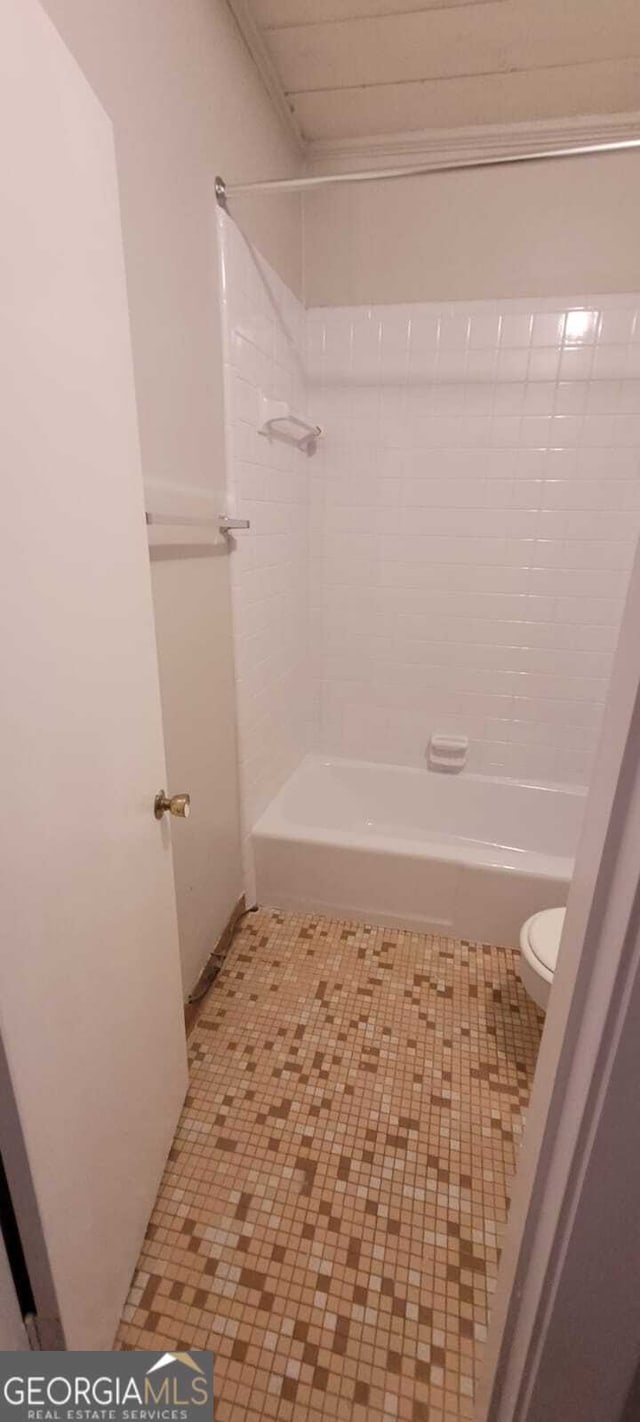 full bathroom featuring tile patterned floors, shower / bath combination, toilet, and ornamental molding