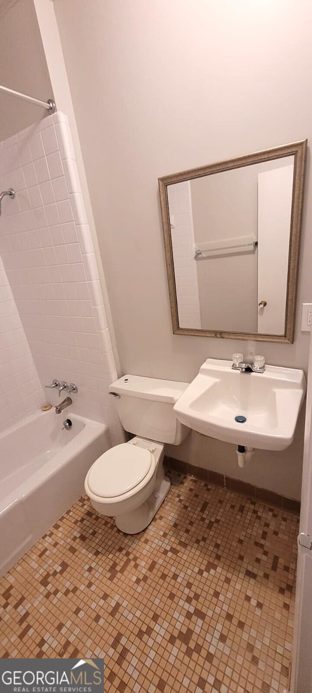 full bath featuring a sink, toilet, shower / washtub combination, and tile patterned flooring