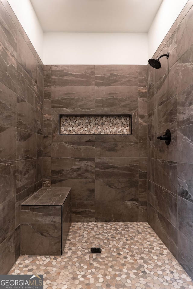 full bath featuring tiled shower