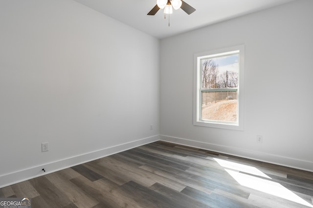 unfurnished room with dark wood finished floors, visible vents, baseboards, and a ceiling fan