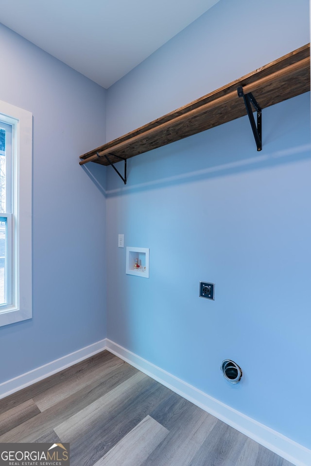 laundry area featuring laundry area, electric dryer hookup, baseboards, and washer hookup