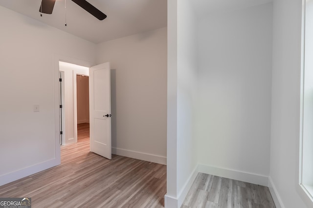 unfurnished bedroom featuring baseboards, light wood finished floors, and ceiling fan