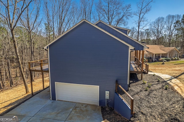 view of side of property with an attached garage and driveway