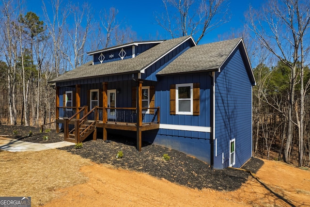 view of front of house with a porch, board and batten siding, and a shingled roof