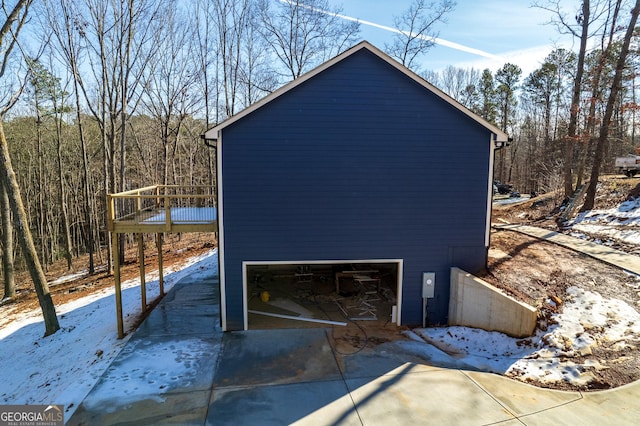 view of snow covered exterior featuring a garage