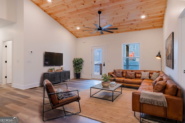 living area with high vaulted ceiling, wood ceiling, ceiling fan, and wood finished floors