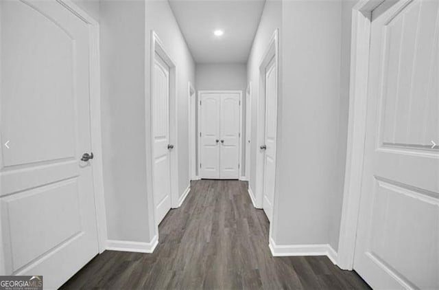 corridor with dark wood-type flooring