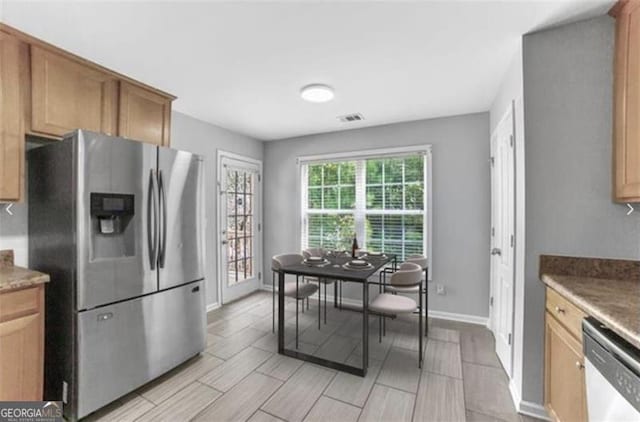 kitchen featuring stone counters and appliances with stainless steel finishes