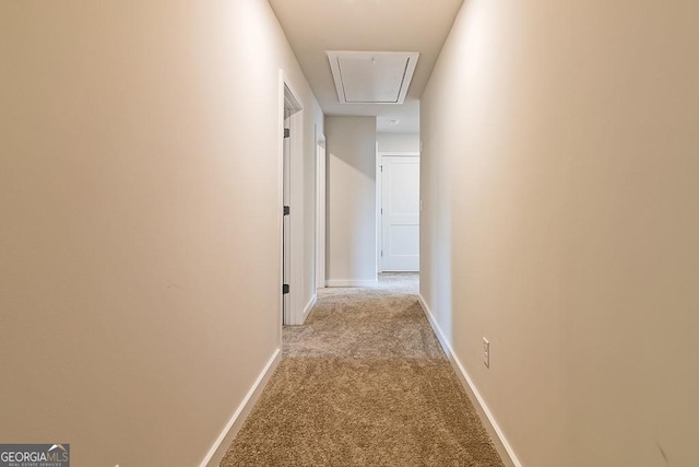 hallway featuring light carpet