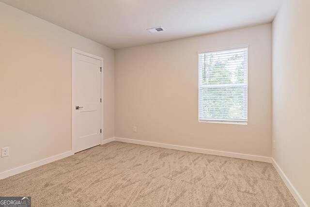 empty room with light colored carpet