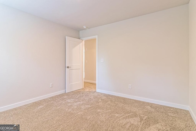 empty room featuring light colored carpet